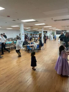 A large parish hall filled with children in costumes and families.